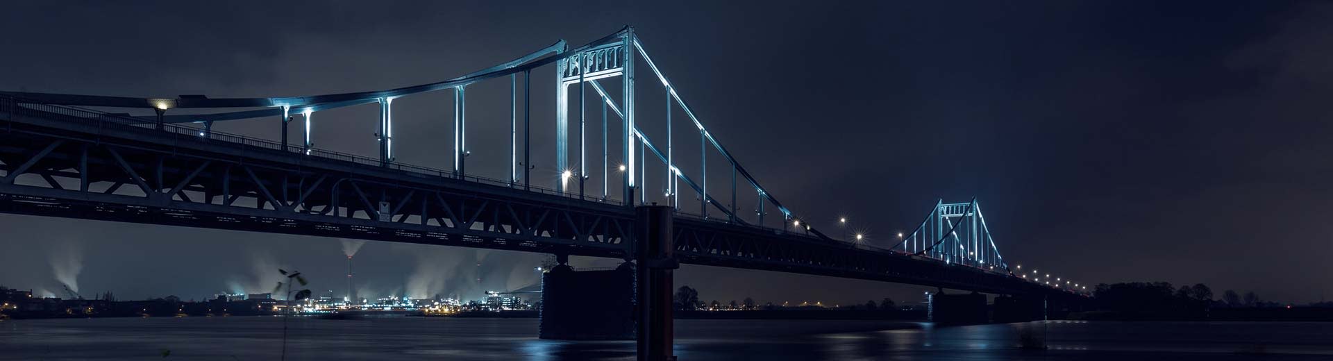 A large suspension bridge in Krefeld at night.