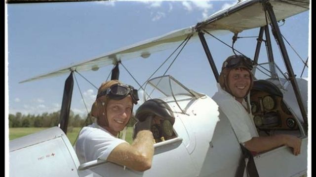 David Gower (left) and John Morris prepare for take-off over the Australian cricket ground, known as the 1991 Tiger Moth incident. Image credit: Getty Images.