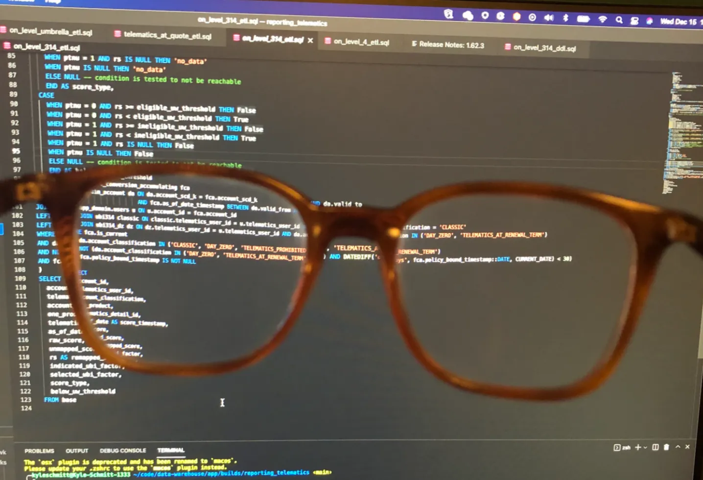 Glasses held up to a computer looking at code