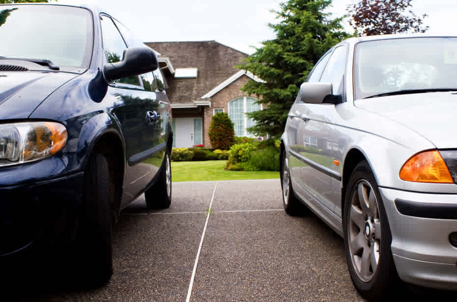 two cars parked in front of house