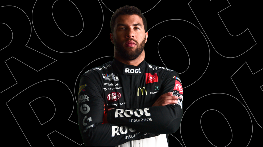 Bubba Wallace standing with his arms crossed