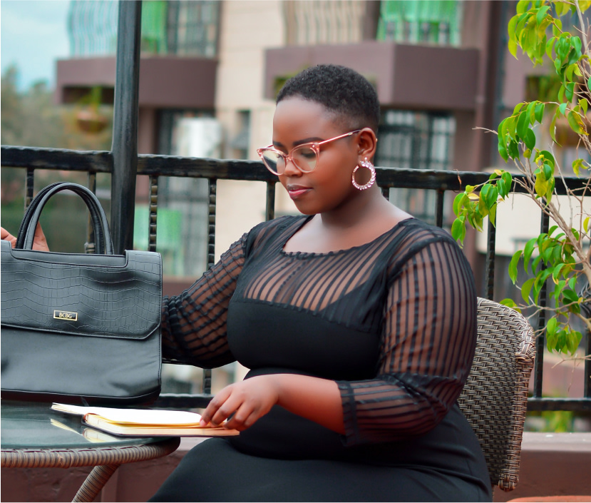 A professional sits at an outdoor workspace organizing her paperwork.