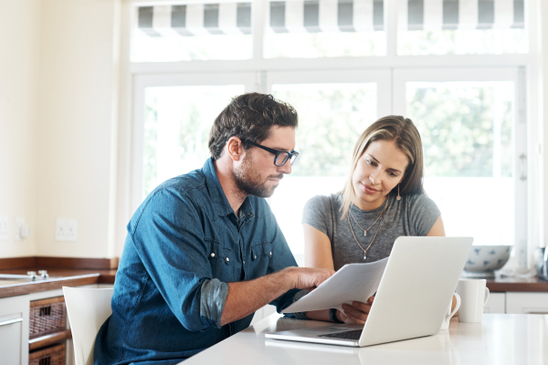 Adult male going through program documents with his coach