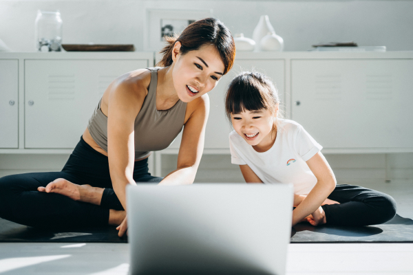 Young mum with her son looking at a laptop