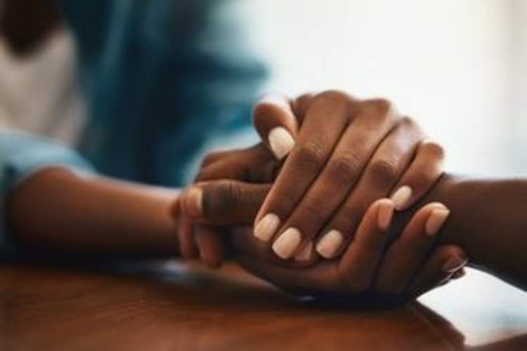 close-up of two people holding hands