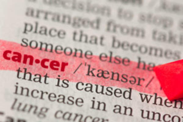 The word cancer highlighted in a dictionary