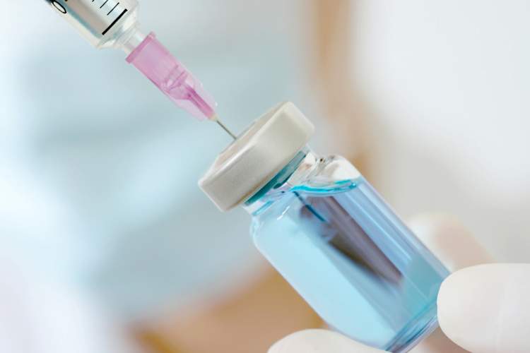 Hand of doctor holding syringe and medicine bottle. Preparing for injection