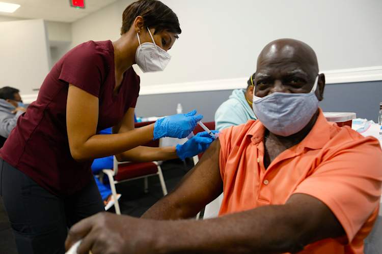 Black man receiving COVID-19 vaccine