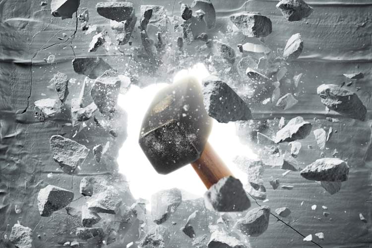 Sledgehammer breaking a wall.