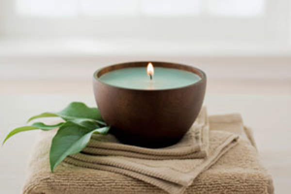 scented candle on towels