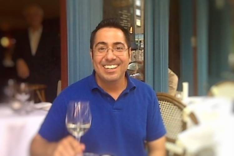 Charles Sanchez with glass of Chardonnay.