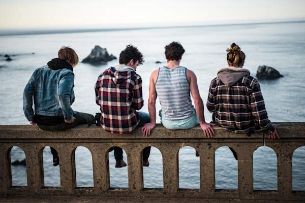 teenage boys sitting on ledge