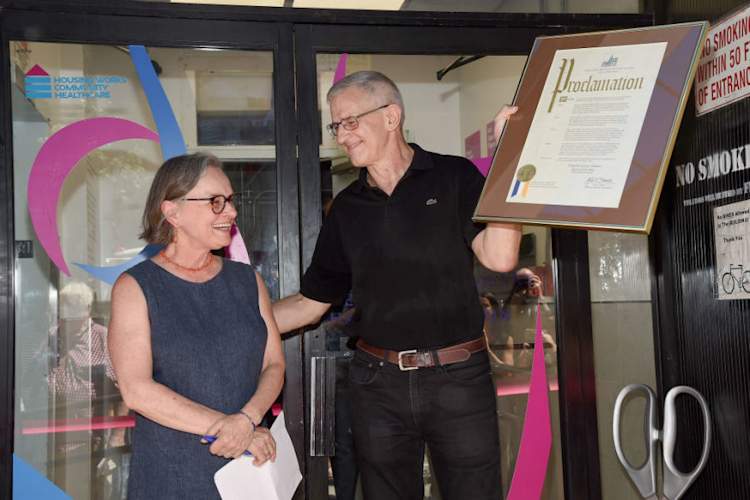Housing Works co-founder Eric Sawyer holding a proclamation with Ginny Shubert during the dedication of The Ginny Shubert Center for Harm Reduction on July 17, 2019 in New York City.