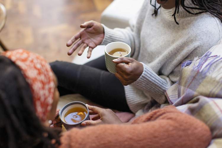 two women talking, focus on hands