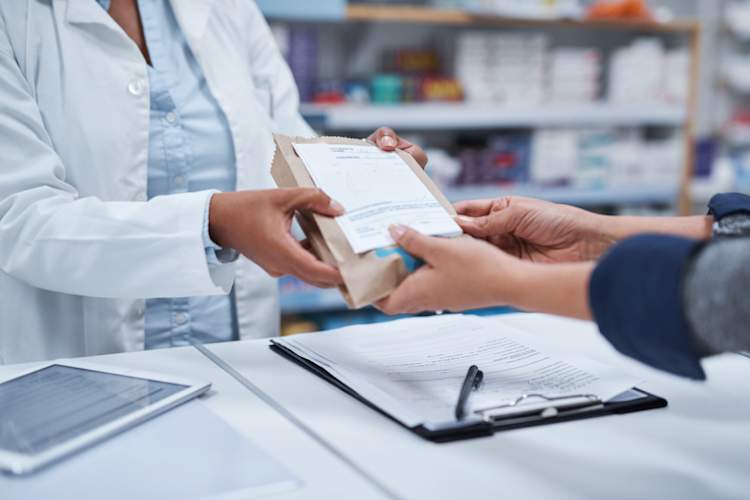 Person picking up prescription from pharmacy