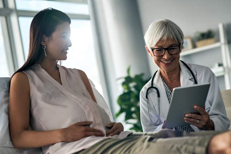 pregnant woman talking to doctor