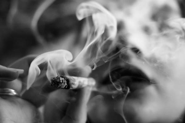 black and white photo of woman smoking cannabis