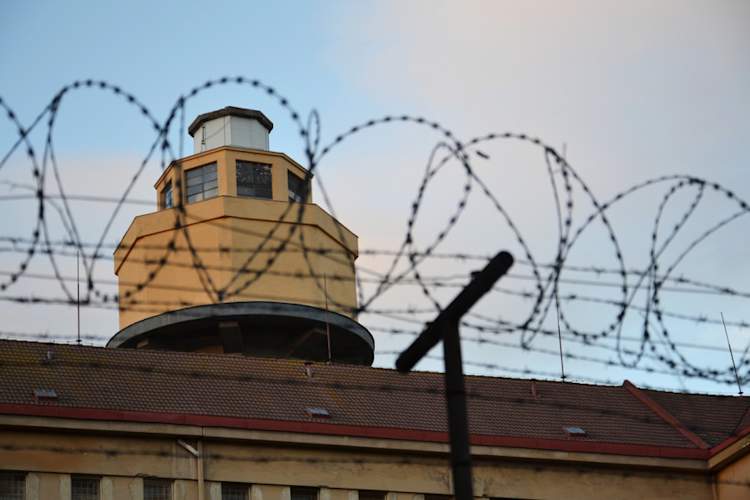 Barbed wire fence layed around prison walls