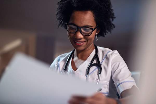 Doctor reading medical records.