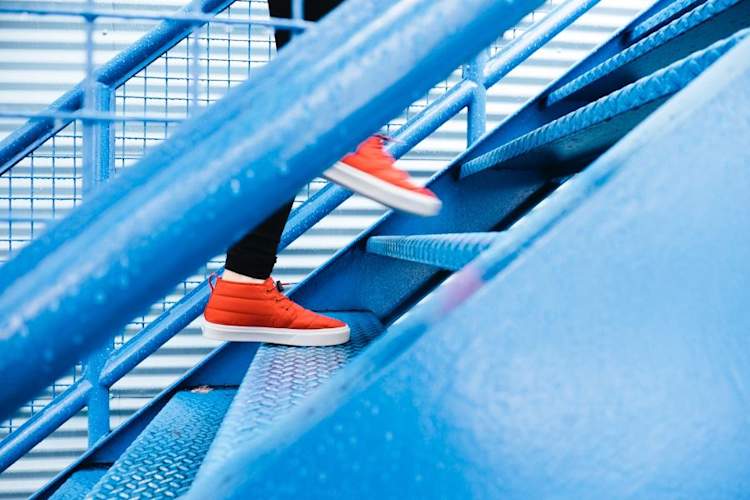 Close up of sneakers walking up stairs