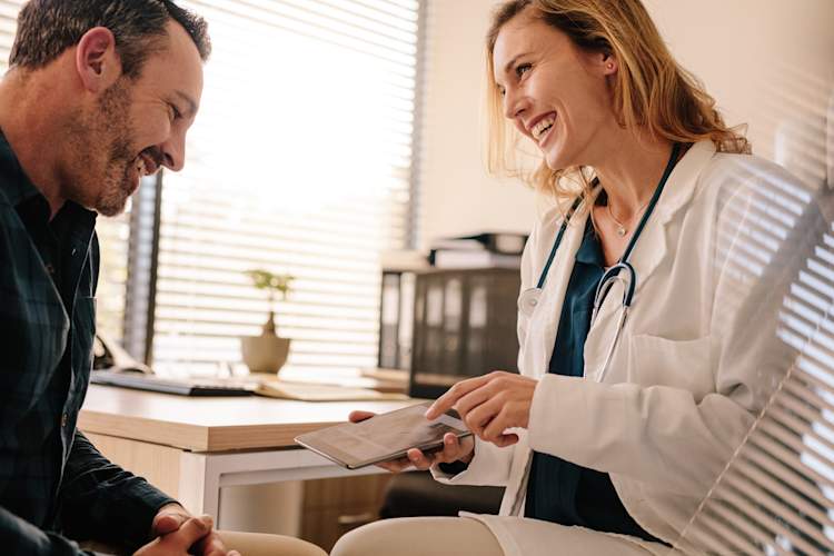 doctor talking and smiling to male patient