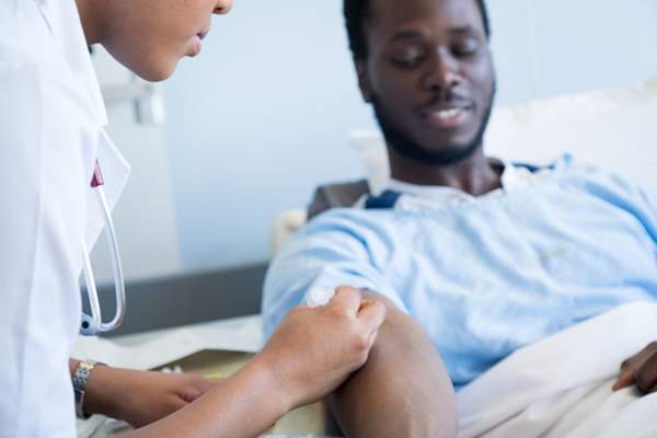 Nurse drawing blood from patient