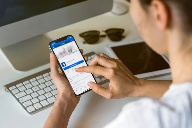 woman using facebook app on phone