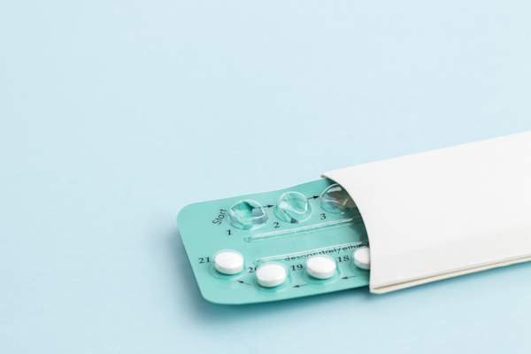 Contraception pills on blue background