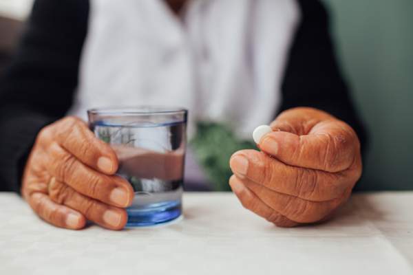 Senior woman taking pills