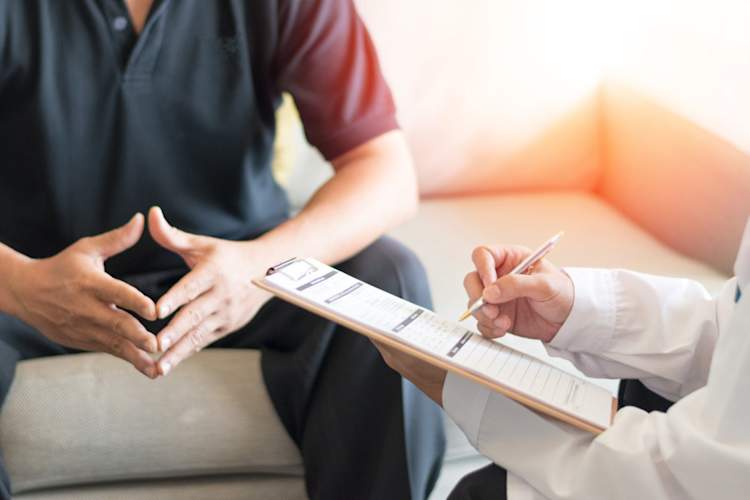 doctor looking at list talking to patient