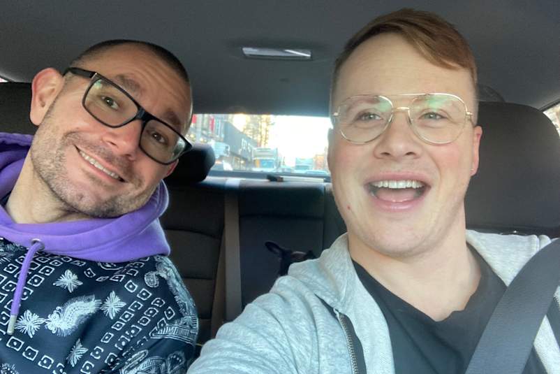 Joe Osmundson in a car with his friend and COVID pod member Lukasz Kowalik.