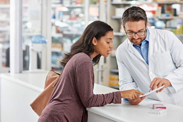 African American woman having heated discussion with pharmacist