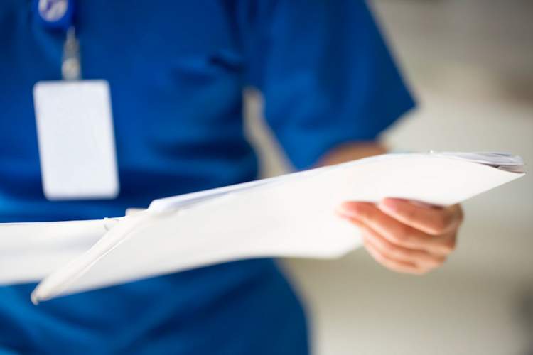 nurse looking at medical chart