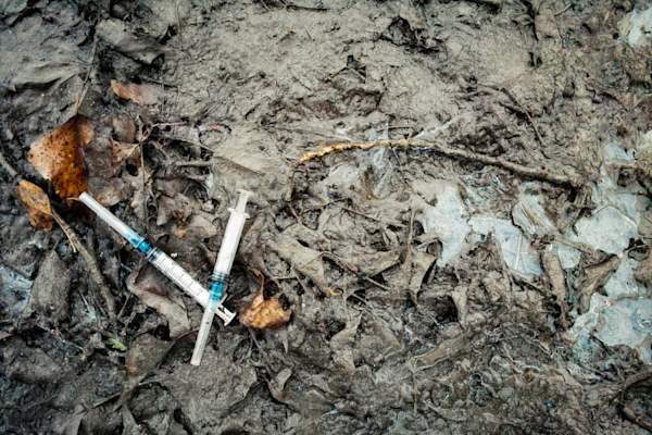 syringes in the mud