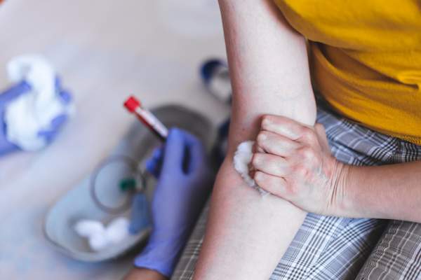 Nurse with blood test and patient