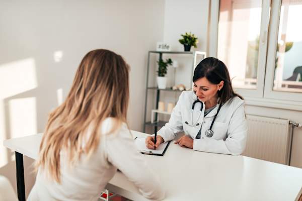 woman talking to doctor