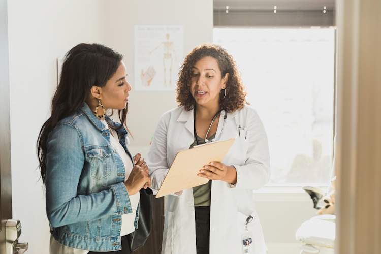 Black patient talking to doctor