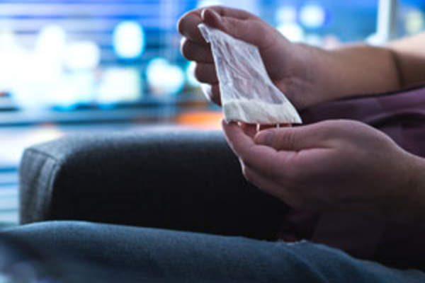 person holding small bag of meth