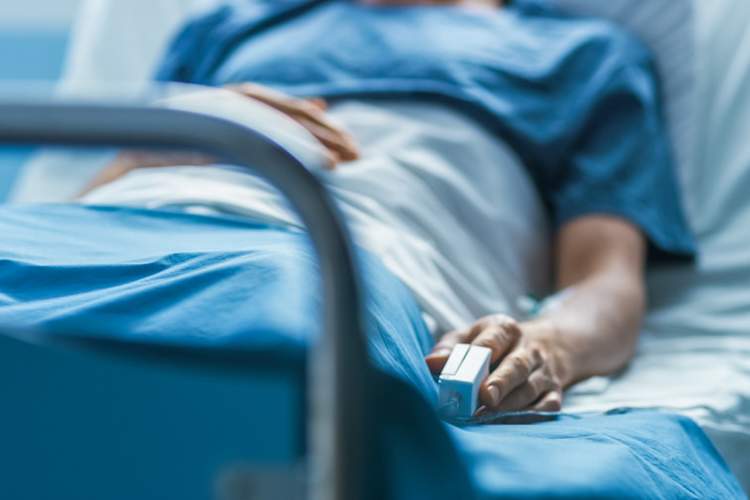 man in hospital bed