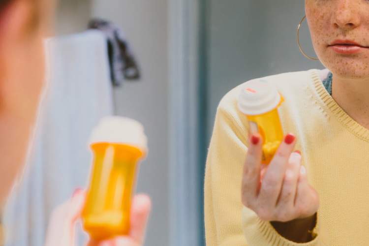 woman looking at prescription