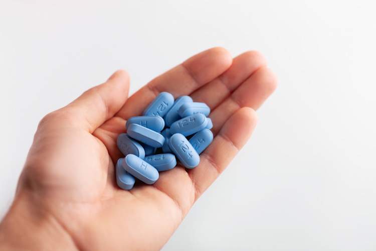 Hand holding many PrEP Pills