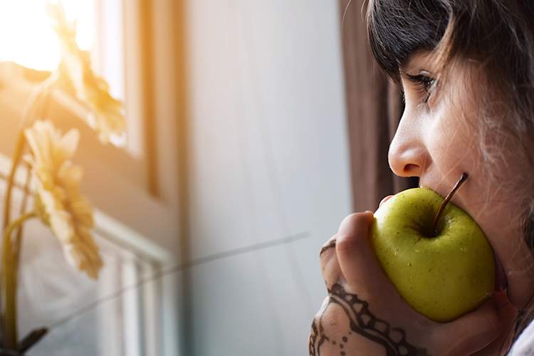 Woman biting into apple