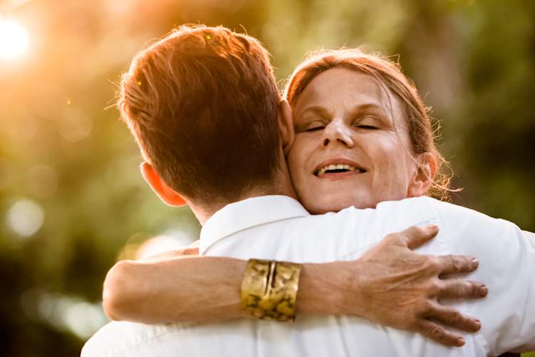 senior mother hugging adult son