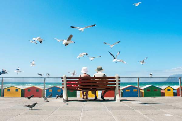 couple on the boardwalk surrounded by seagulls