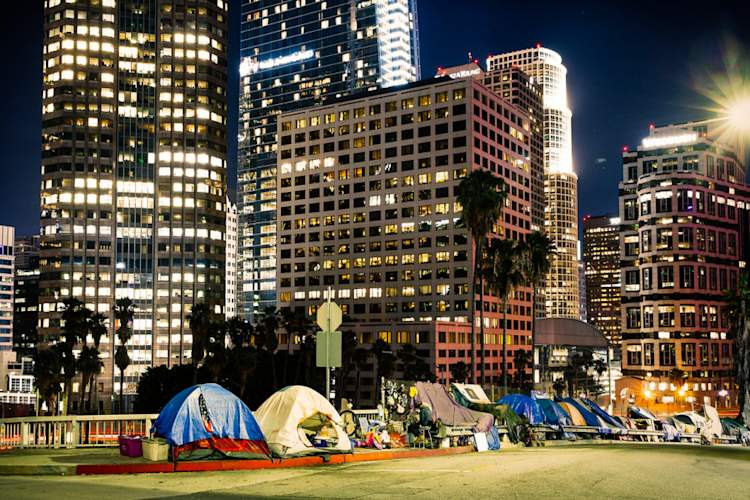 tents under downtown Los Angeles skyline