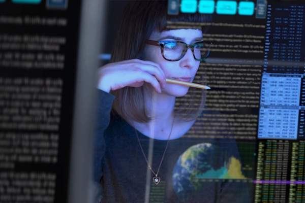 woman looking at data on computer
