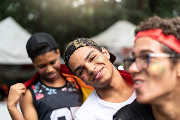 young gay latino man at pride parade