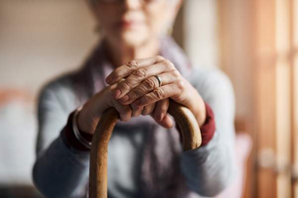 Senior hands with cane
