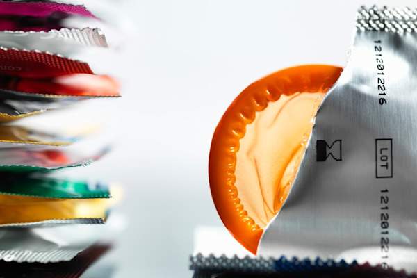 Torn packaging of wrapper containing a condom