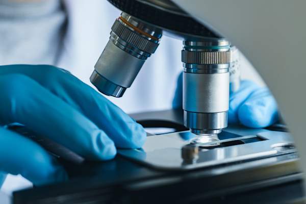 Scientist looking into microscope